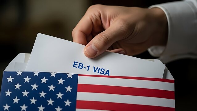 Hand holding EB-1 visa document inside an American flag envelope