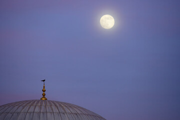 Full moon over mosque dome; nature and natural botanical sky for wellness, calm, relaxation and mindfulness. Harmony and balance background with copy space for banner or eco poster.