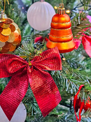 Christmas tree decoration with red and golden baubles and ornaments