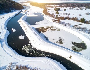 Aerial View of Snowy River Landscape with Frozen Water.