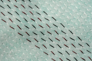 Textured fabric with vibrant stitching in a soothing mint color