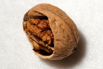 Close-up of a cracked walnut revealing its rich, textured interior