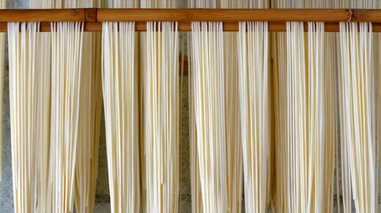 somen. Thin white Japanese somen noodles arranged neatly on a traditional bamboo drying rack, highlighting texture and orderly lines. lifestyle magazines.
