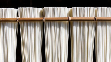 somen. Thin white Japanese somen noodles arranged neatly on a traditional bamboo drying rack, highlighting texture and orderly lines. lifestyle magazines.
