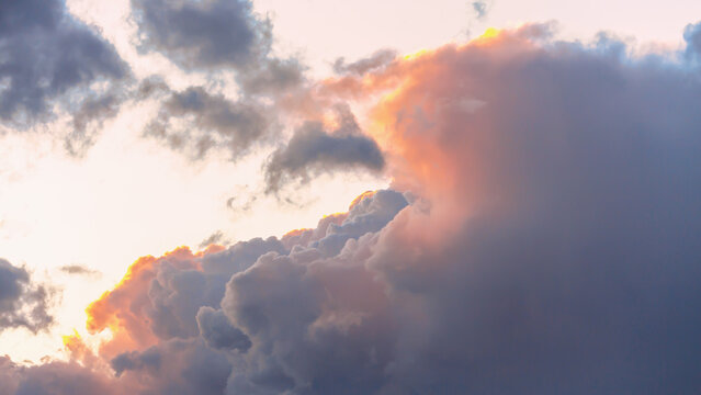 Soft illuminated storm clouds during sunset with pastel tones in dramatic sky - Powered by Adobe