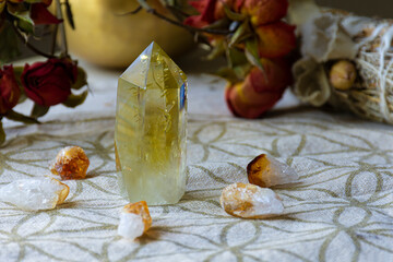 A close up image of large citrine crystal on a grid cloth using sacred geometry to invoke a self healing process. 