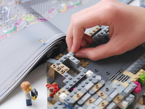 Tambov, Russian Federation - January 01, 2026 A young man assembling a lego set. Close up.