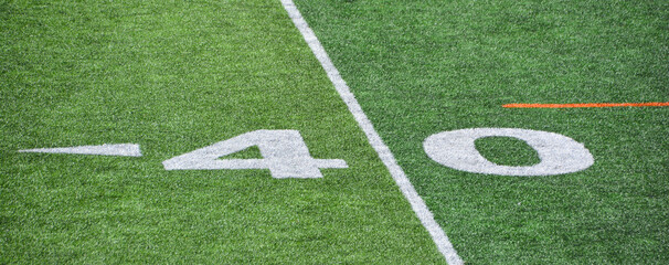 The 40-yard-line of an american football field with artificial turf