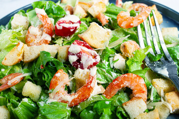 Caesar salad, with shrimp, on a marble background, top view, no people,