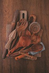 Wooden kitchen utensils neatly arranged on a wooden surface creating a rustic cooking aesthetic