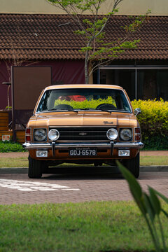 Golden classic Chevrolet Opala front view, Vintage Brazilian muscle car parked