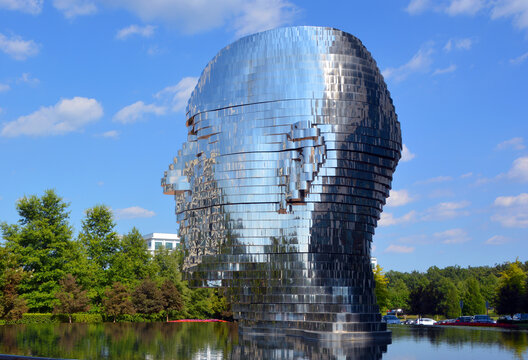 CHARLOTTE NC USA JUNE 24 2016:  The "Metamorphosis" in Charlotte, NC is the kinetic sculpture officially named Metalmorphosis by Czech artist David Cerny. Stainless steel sculpture of a human head 