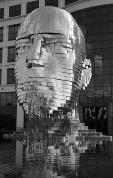 CHARLOTTE NC USA JUNE 24 2016:  The "Metamorphosis" in Charlotte, NC is the kinetic sculpture officially named Metalmorphosis by Czech artist David Cerny. Stainless steel sculpture of a human head 