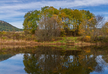 Autumn river landscape with colorful trees reflections
