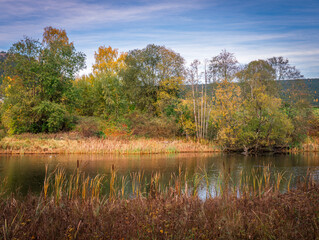 Autumn river landscape with colorful trees reflections