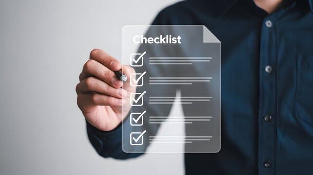 Person marking a digital checklist with a pen.