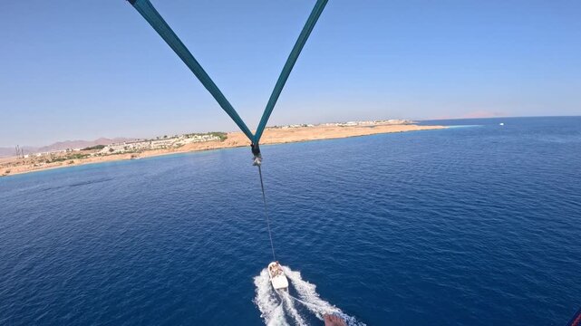Parasailing Over Red Sea From Point Of View In Slow Motion, Summer Water Sport Adventure Flying On Parachute Behind Boat, Tropical Resort Holiday Travel Experience In Egypt