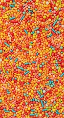 A vibrant, colorful texture made of small, assorted confectionery sprinkles, forming a fun, sugary, and abstract seamless background pattern ,wallpaper ,sugar ,rainbow