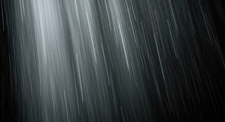 Dramatic display of rapid white rain streaks pouring down vertically, forming an abstract natural pattern of high contrast and motion ,abstract ,liquid ,dramatic