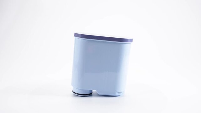 Coffee machine water filter rotating vertically on white background. A neat studio animation demonstrates the plastic body, cylindrical shape and filter element of home coffee machines.