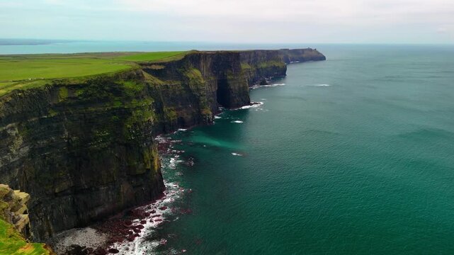 Aerial drone view of the Cliffs of Moher in Ireland. Dramatic coastal cliffs and the vast Atlantic Ocean. One of the most beautiful natural landmarks in Ireland.