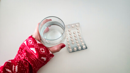 Woman holding blister pack pills
