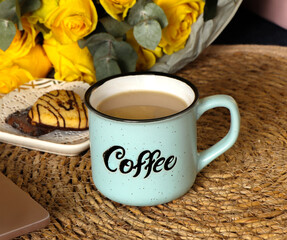 Cozy rustic coffee cup on woven straw surface with warm autumn decor, hygge still life, slow living morning concept. High quality photo