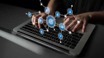 A close-up view of hands typing on a laptop keyboard, overlaid with digital connection graphics representing networking and technology in a professional setting. Tessel