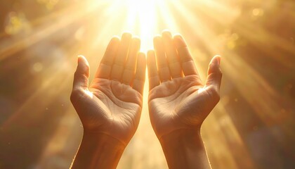 Two hands held open and upwards towards a bright glowing light representing hope and spiritual connection