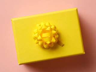 Yellow paper bow on yellow gift box