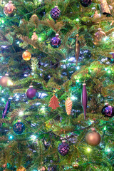 Vertical close-up view of a decorated natural Christmas tree
