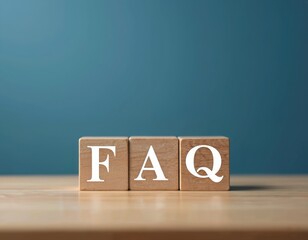 Three wooden blocks with letters F, A, Q arranged on a table. The acronym FAQ stands for frequently asked questions. This concept relates to customer support and obtaining information.