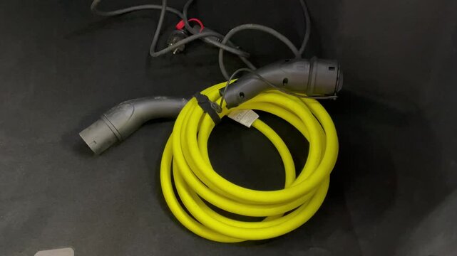 Coiled electric car charging cable neatly stored in the trunk organized cable tidy and clean modern car technology