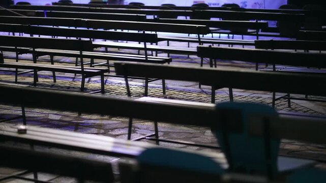 Empty wooden benches in open air outdoor city public event space or stage. Selective focus