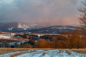 Winter snowy cold sunrise near Roprachtice village in Krkonose mountains