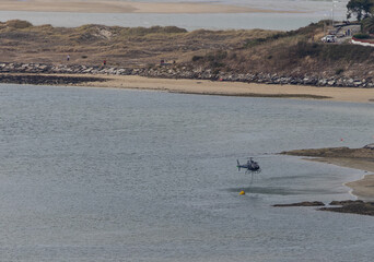 Obraz premium Summer wildfire, where helicopters are working non-stop dropping water!