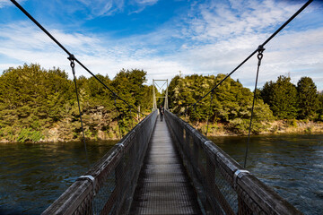 Tourist Crossing Swing Bridge on Kepler Track