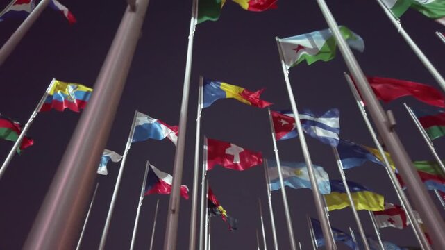 Waving flags at the Flag Plaza, displays 119 flags from countries with authorized diplomatic missions, slow motion