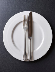 plate and fork on black background