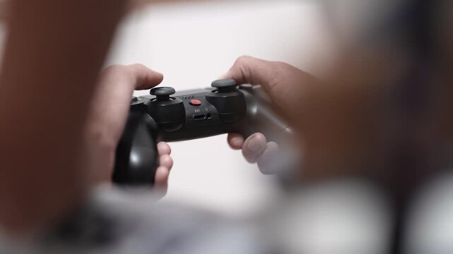 Man hand playing a computer games holding modern controller joistic