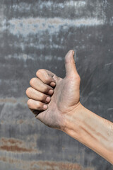 Industrial worker hand giving thumbs up sign after quality inspection