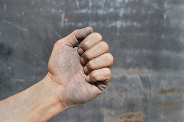 Clenched industrial worker hand symbolizing labor strength and endurance