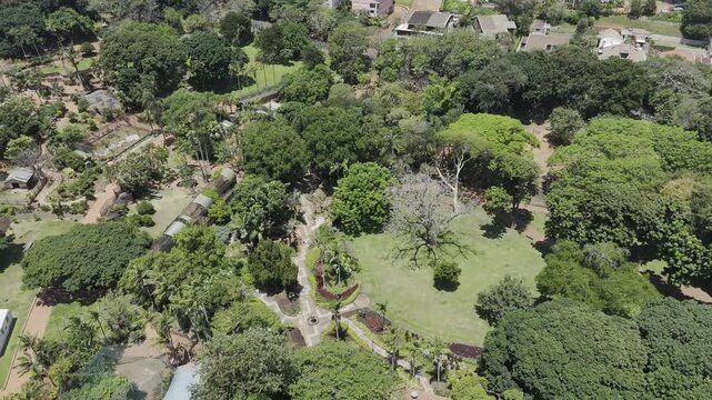 Drone lowers over center of Mitchell Park on sunny day in Morningside neighborhood in Durban, South Africa