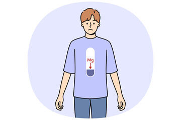 Magnesium deficiency in body of man with MG scale on stomach, and negative emotions on face. Problem of magnesium deficiency negatively affects health of bones and teeth or cardiovascular system