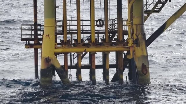 Waves Hit Oil and Gas Producing Slots and Surface Casings at Offshore Platform
