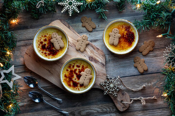 Homemade festive Creme Brulee dessert ramekins with gingerbread men. 