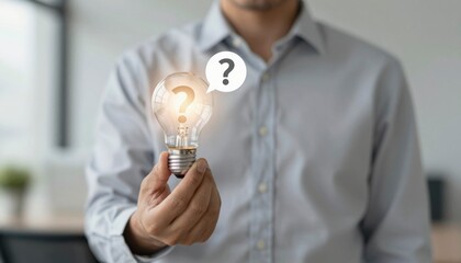 Curious Hand Holding Glowing Light Bulb