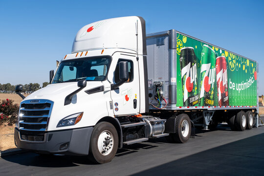 Truck showing pictures of assorted flavors 7up brand of sodas parked at a customer parking lot waiting to deliver an order	