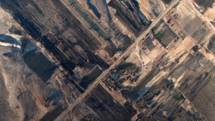 Aerial View of Rural Geometric Agricultural Fields with Roads and Natural Landscape Patterns at Sunset