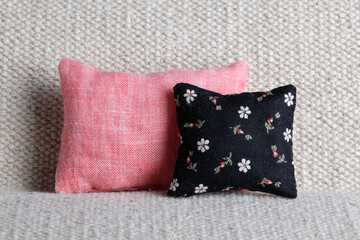 Pink and black cushions with floral pattern on sofa